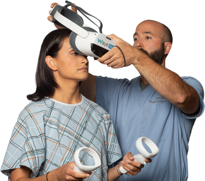 A doctor is about to place a virtual reality headset on a woman patient.